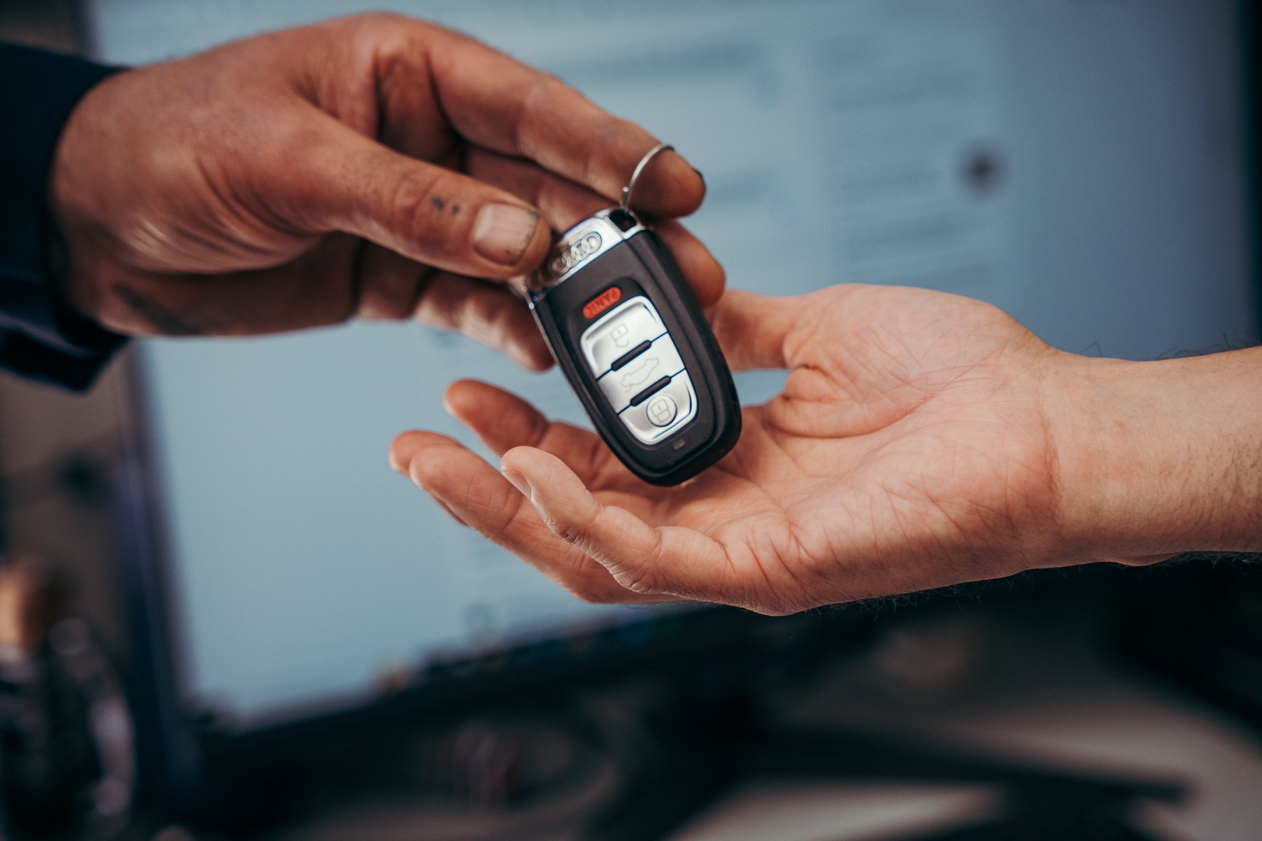Vehicle keys being handed to a customer