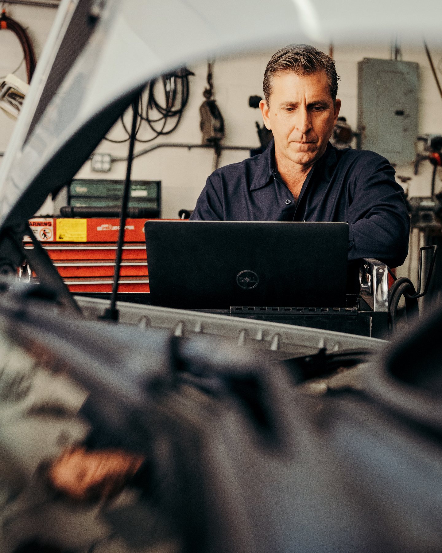 Luke Bennett using a laptop for vehicle diagnostics